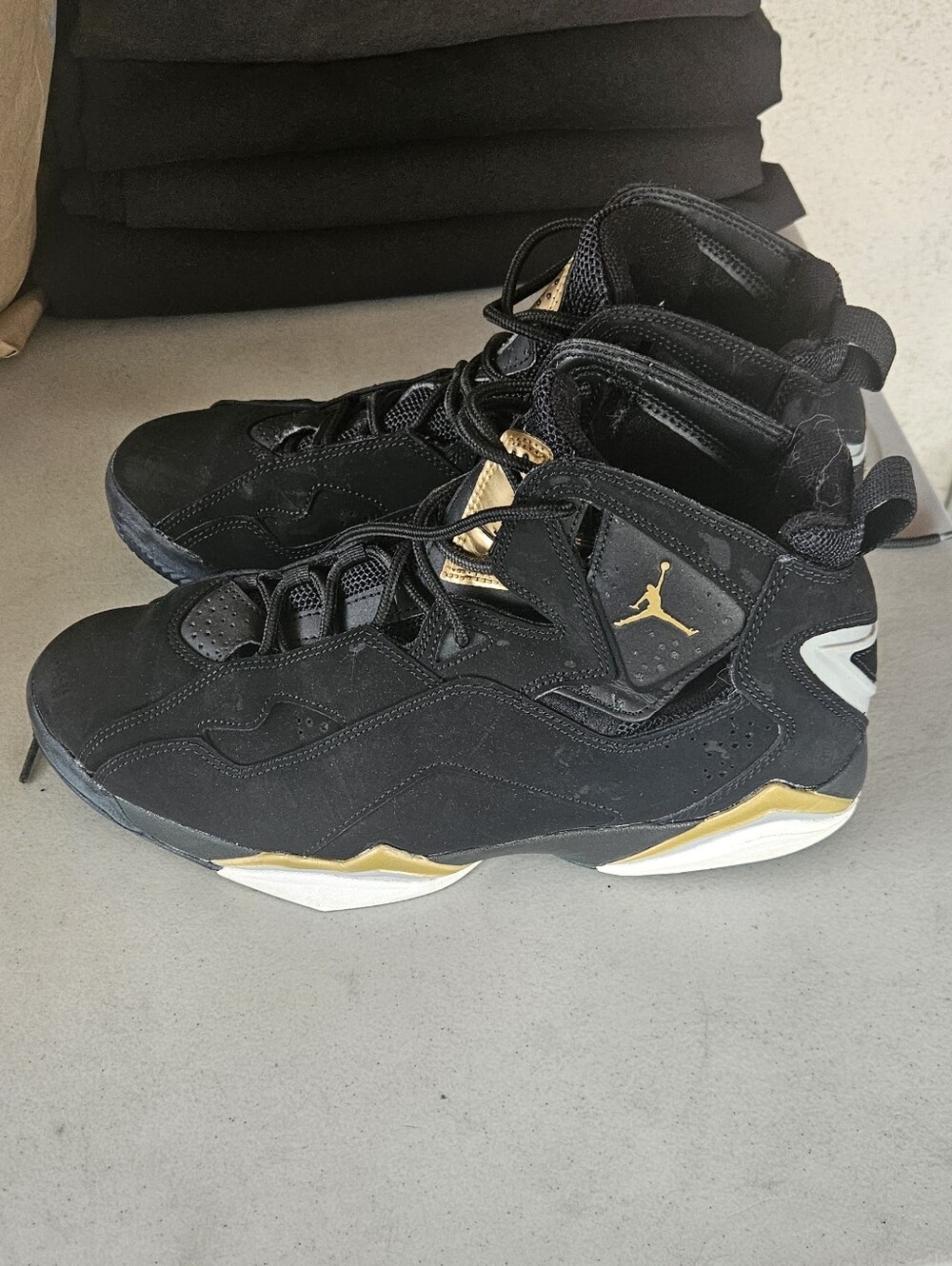 Nike Jordan True Flight shoes in a black and metallic gold